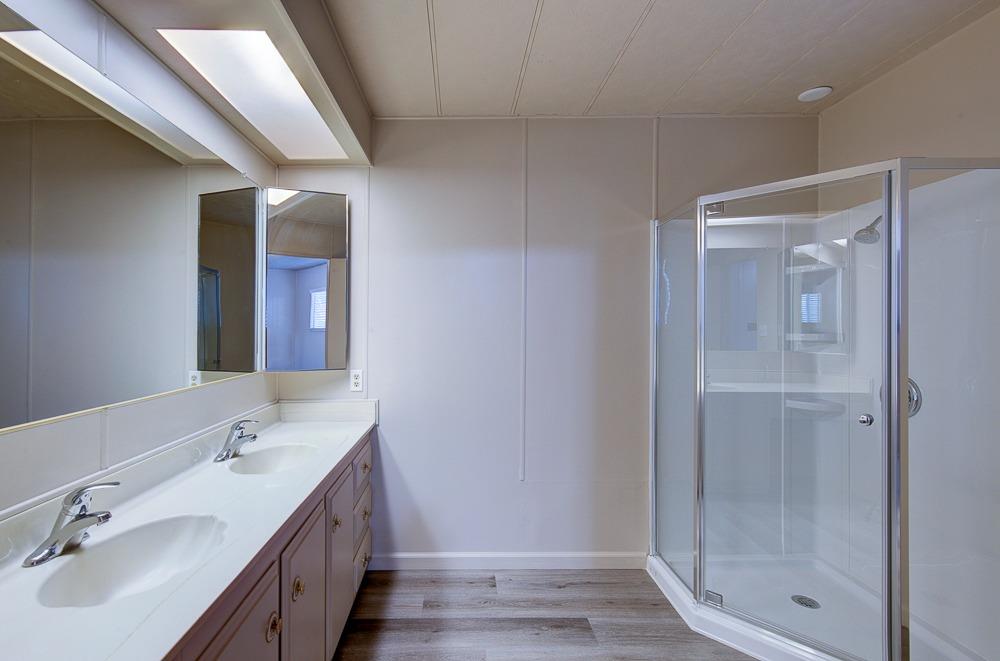 1500 Villa Avenue, Unit 27 Clovis, CA 93612 - Photo 25 of 29 a bathroom with a shower sink and mirror
