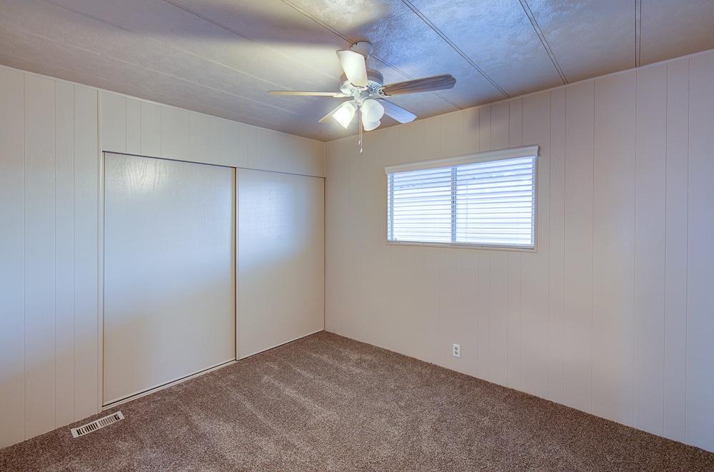 1500 Villa Avenue, Unit 27 Clovis, CA 93612 - Photo 27 of 29 an empty room with a ceiling fan and a window