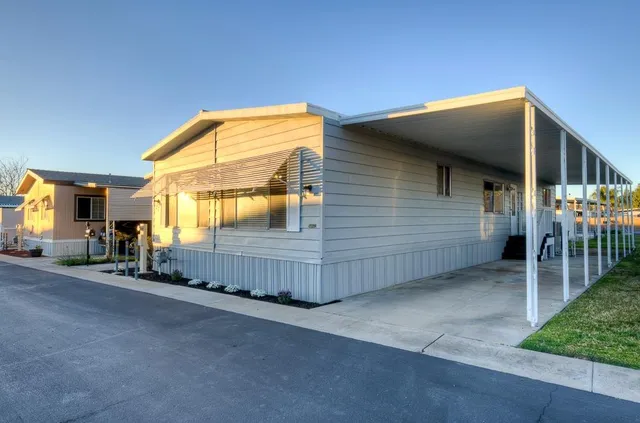 a view of a house with wooden fence