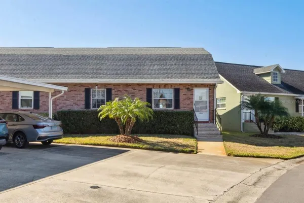 a view of a building with cars parked