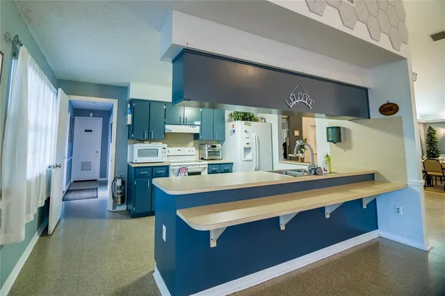a view of kitchen island a sink a counter space and appliances