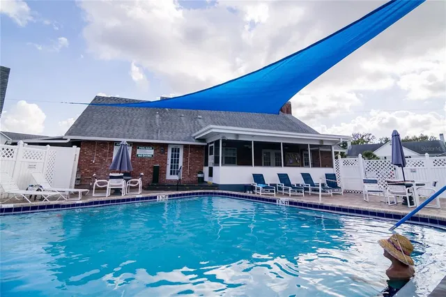 a view of a house with swimming pool and sitting area
