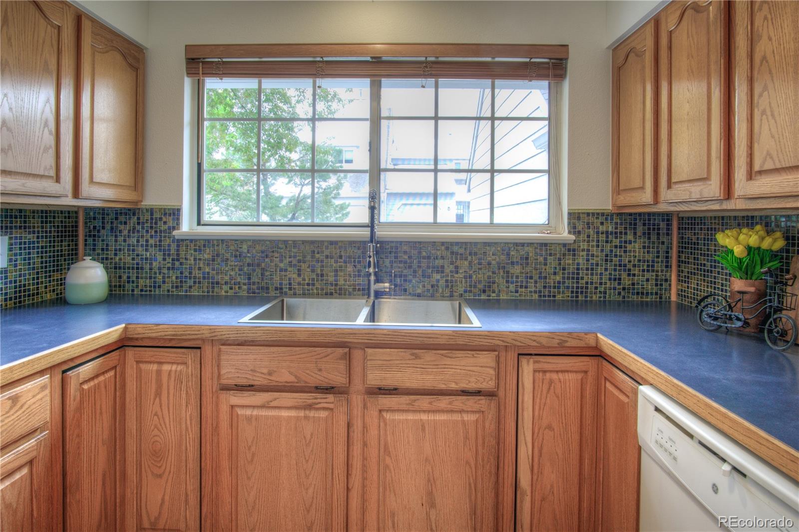 10385 East Red Mountain Road Littleton, CO 80127 - Photo 11 of 47 a kitchen with stainless steel appliances white cabinets and a sink
