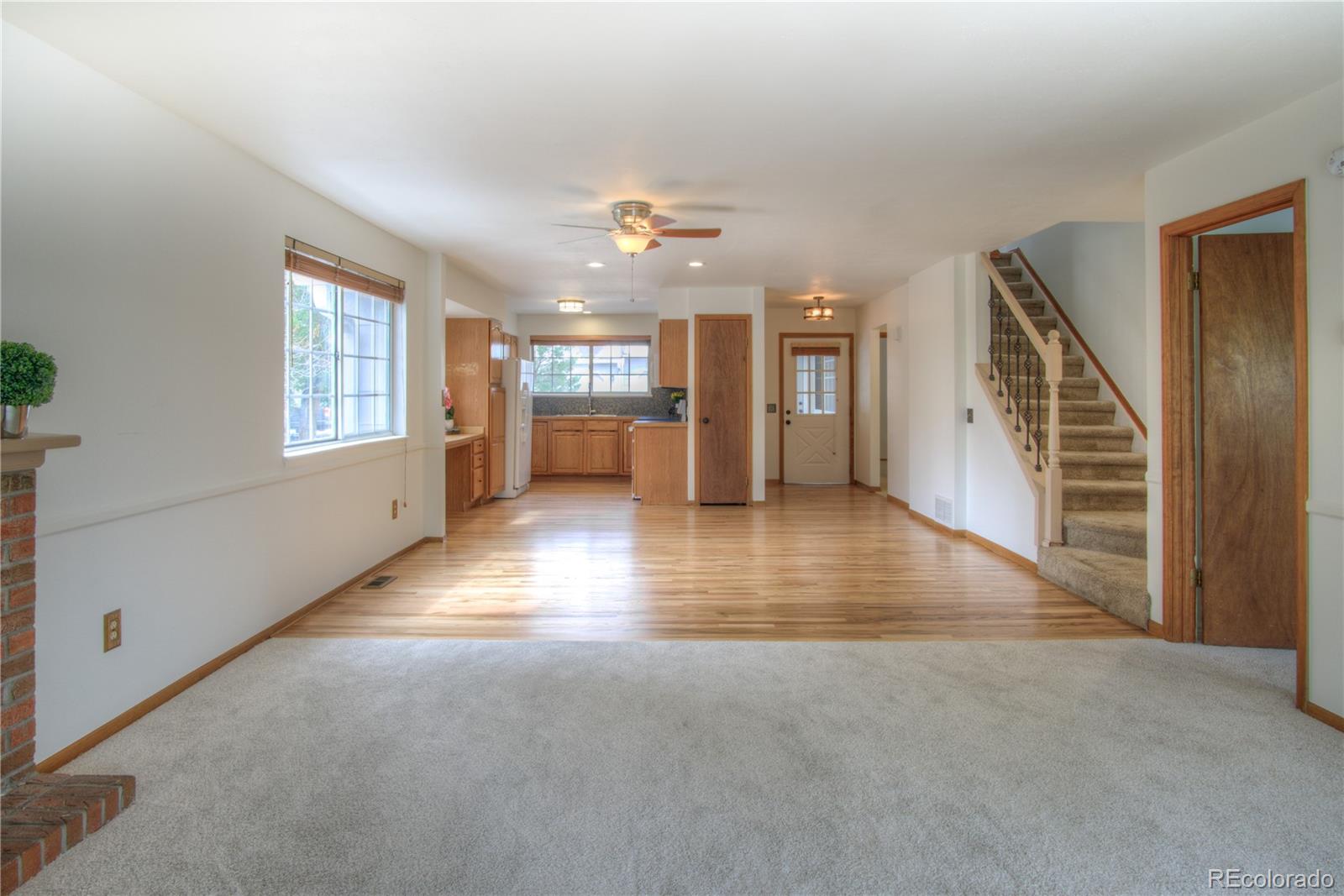 10385 East Red Mountain Road Littleton, CO 80127 - Photo 12 of 47 an empty room with windows and ceiling fan