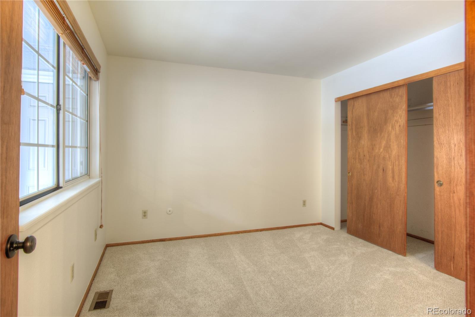 10385 East Red Mountain Road Littleton, CO 80127 - Photo 22 of 47 a view of an empty room with a window