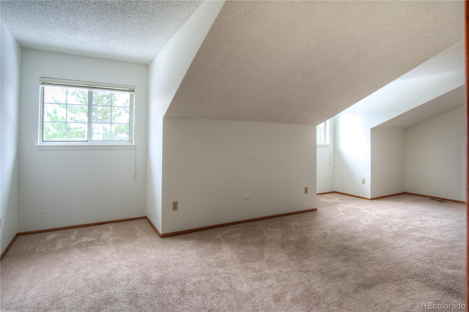 10385 East Red Mountain Road Littleton, CO 80127 - Photo 25 of 47 an empty room with windows