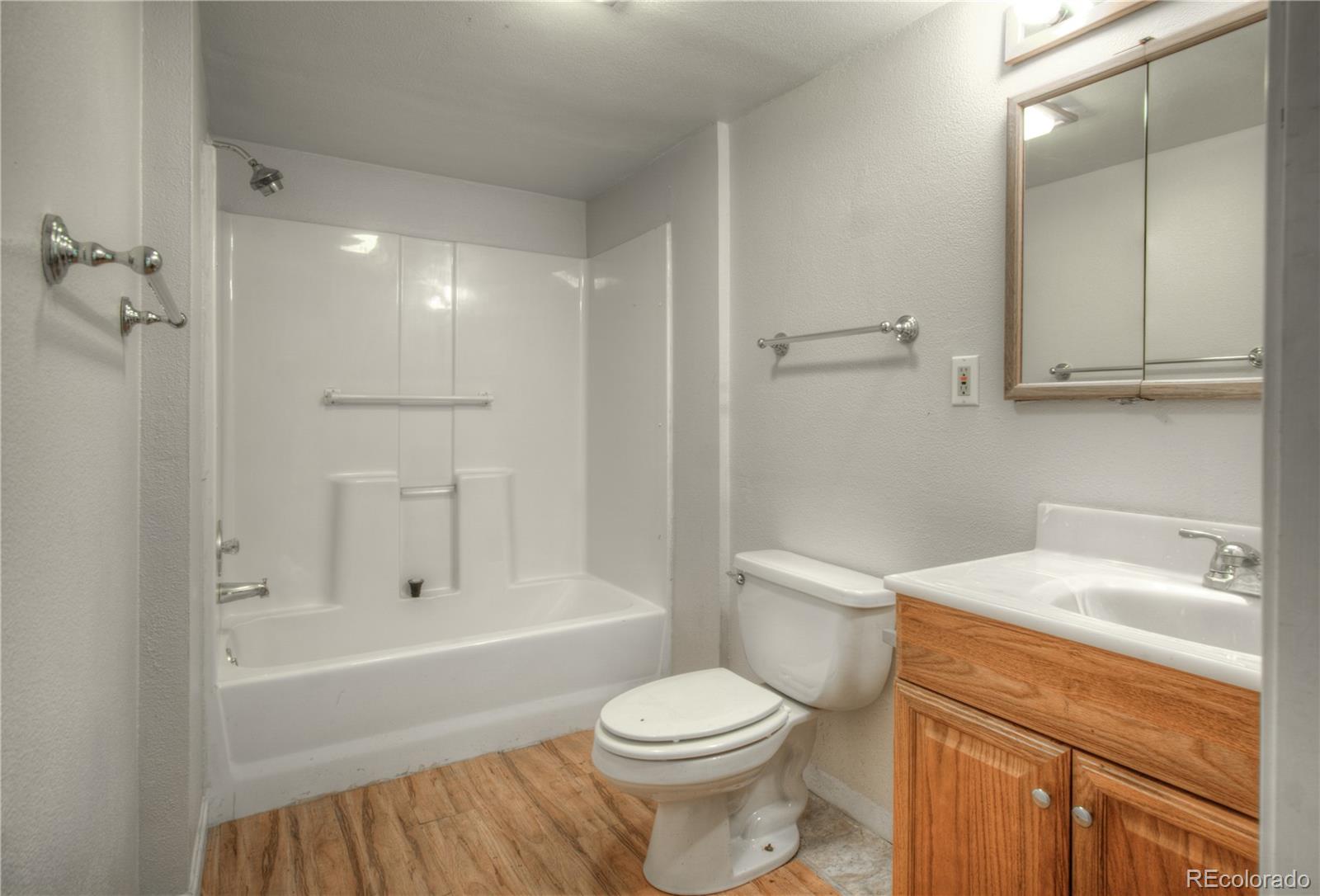 10385 East Red Mountain Road Littleton, CO 80127 - Photo 28 of 47 a bathroom with a sink toilet vanity and shower