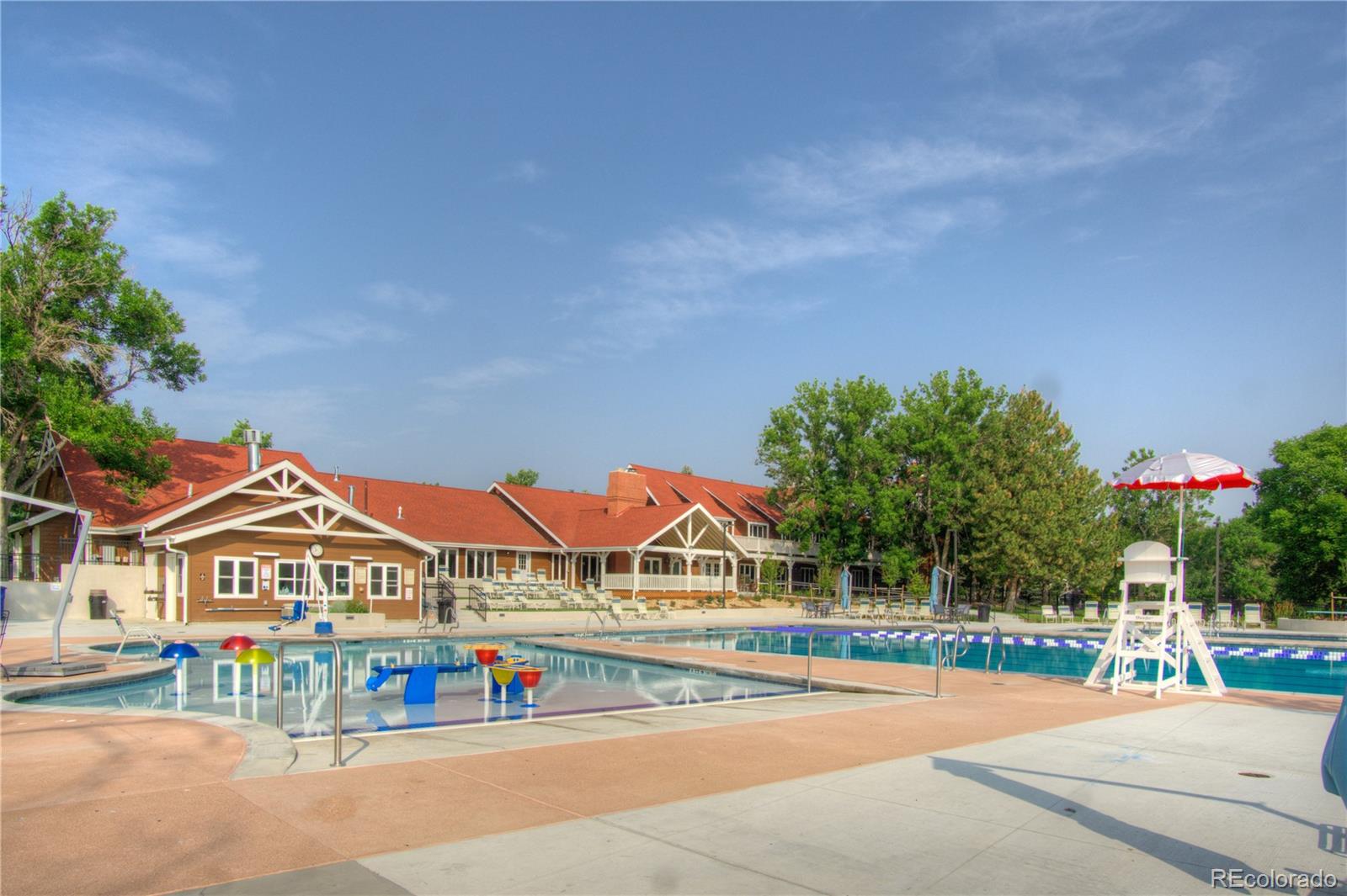 10385 East Red Mountain Road Littleton, CO 80127 - Photo 46 of 47 a view of pool with lawn chairs and large trees
