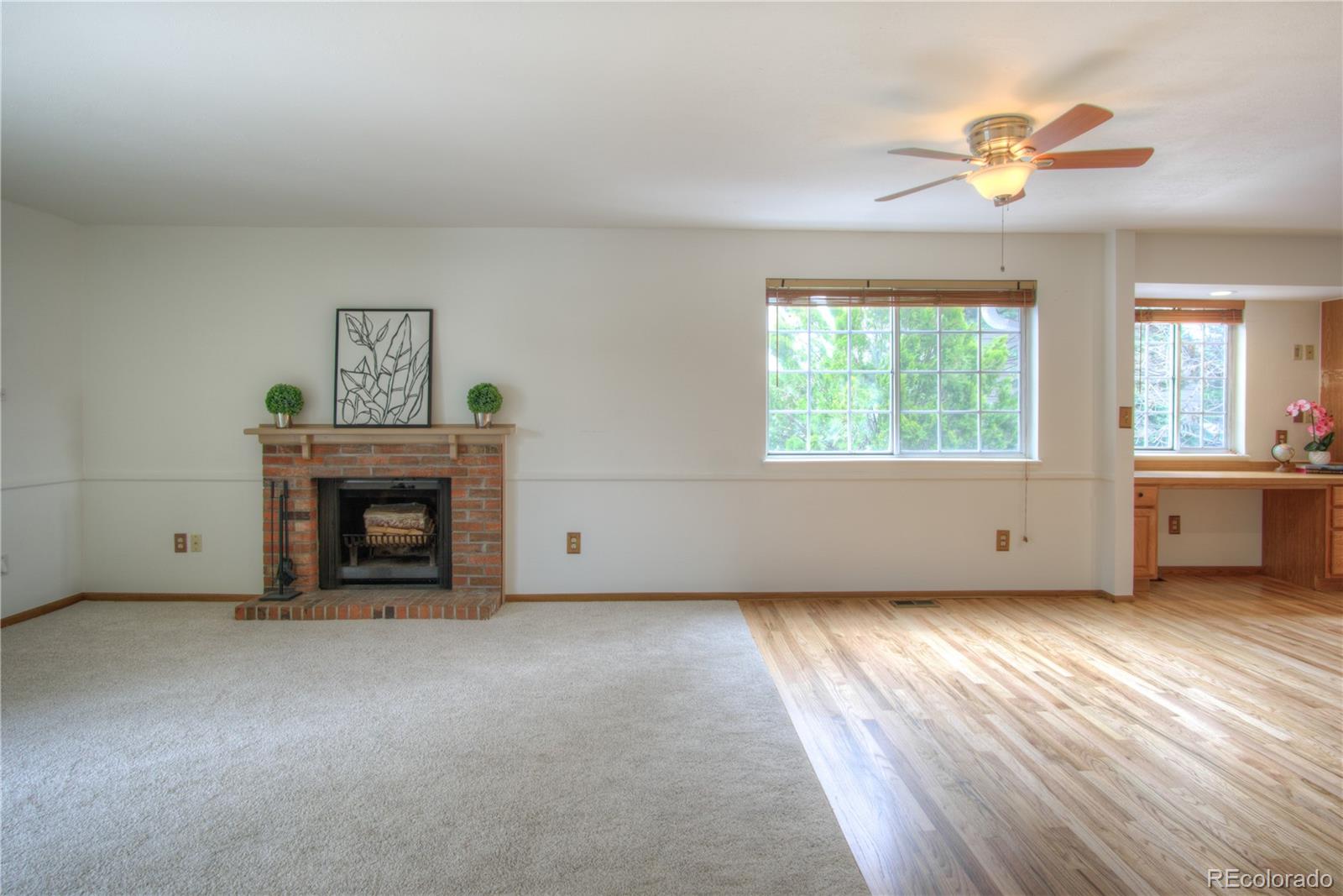 10385 East Red Mountain Road Littleton, CO 80127 - Photo 5 of 47 a view of an empty room with a window and fireplace