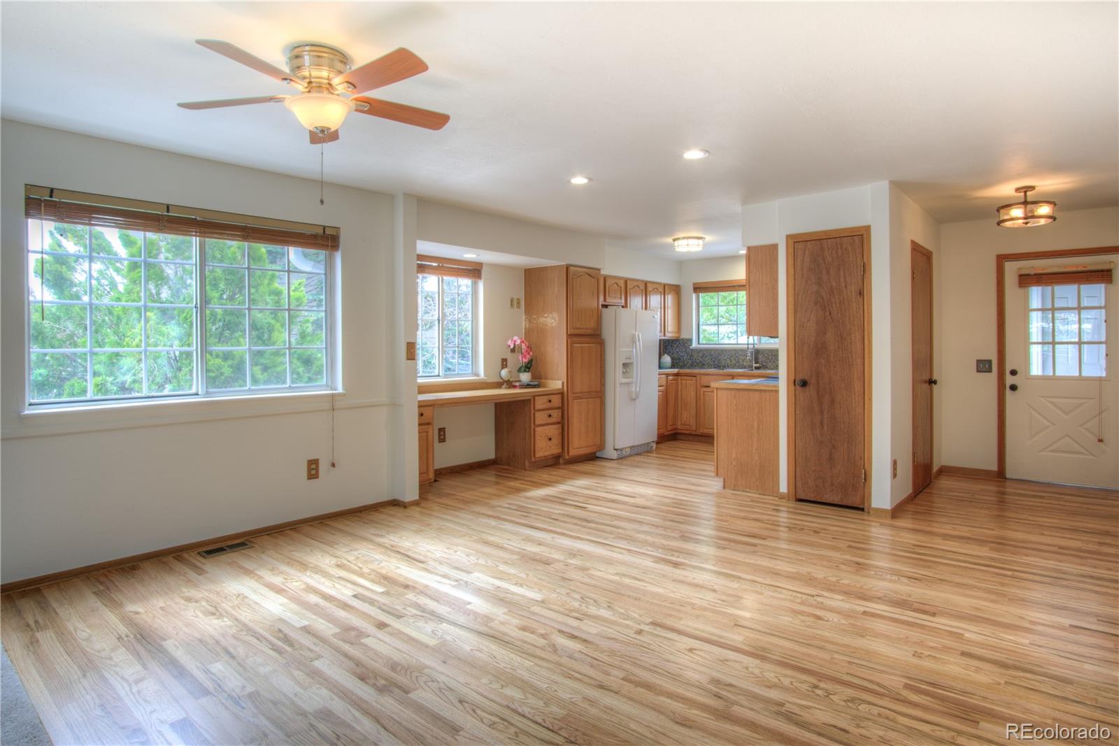 10385 East Red Mountain Road Littleton, CO 80127 - Photo 7 of 47 a view of a kitchen with a stove cabinets and wooden floor