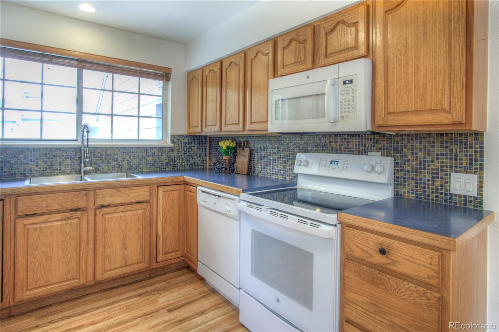 10385 East Red Mountain Road Littleton, CO 80127 - Photo 10 of 47 a kitchen with stainless steel appliances granite countertop a sink a stove and cabinets