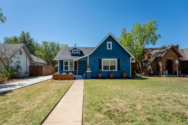 a front view of a house with yard patio and fire pit