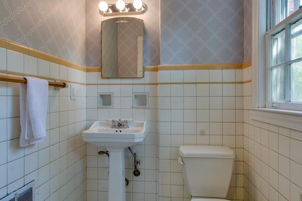 1109 Neelys Bend Road Madison, TN 37115 - Photo 12 of 30 a bathroom with a sink a toilet and mirror