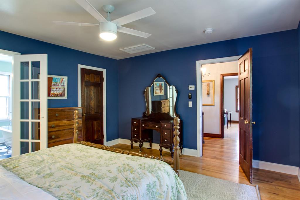 1109 Neelys Bend Road Madison, TN 37115 - Photo 17 of 30 a bedroom with a bed and wooden floor