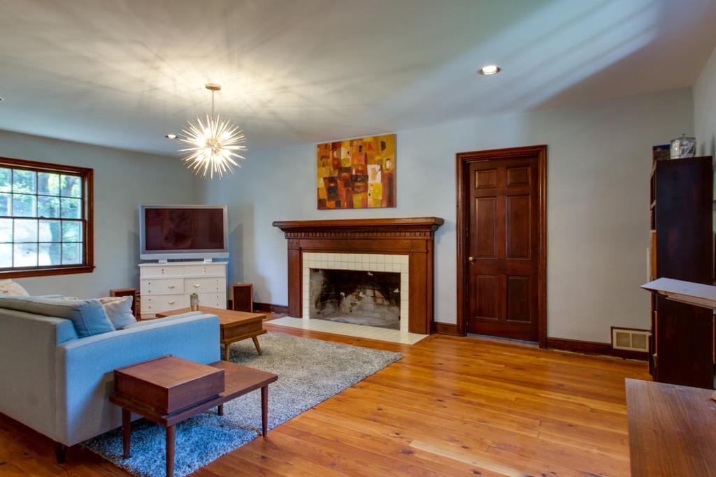 1109 Neelys Bend Road Madison, TN 37115 - Photo 3 of 30 a living room with furniture a flat screen tv and a fireplace