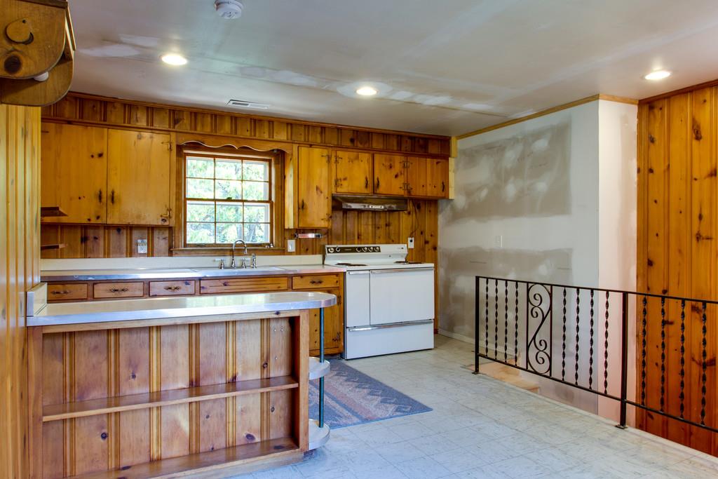 1109 Neelys Bend Road Madison, TN 37115 - Photo 25 of 30 a kitchen with stainless steel appliances granite countertop a stove a sink and a refrigerator