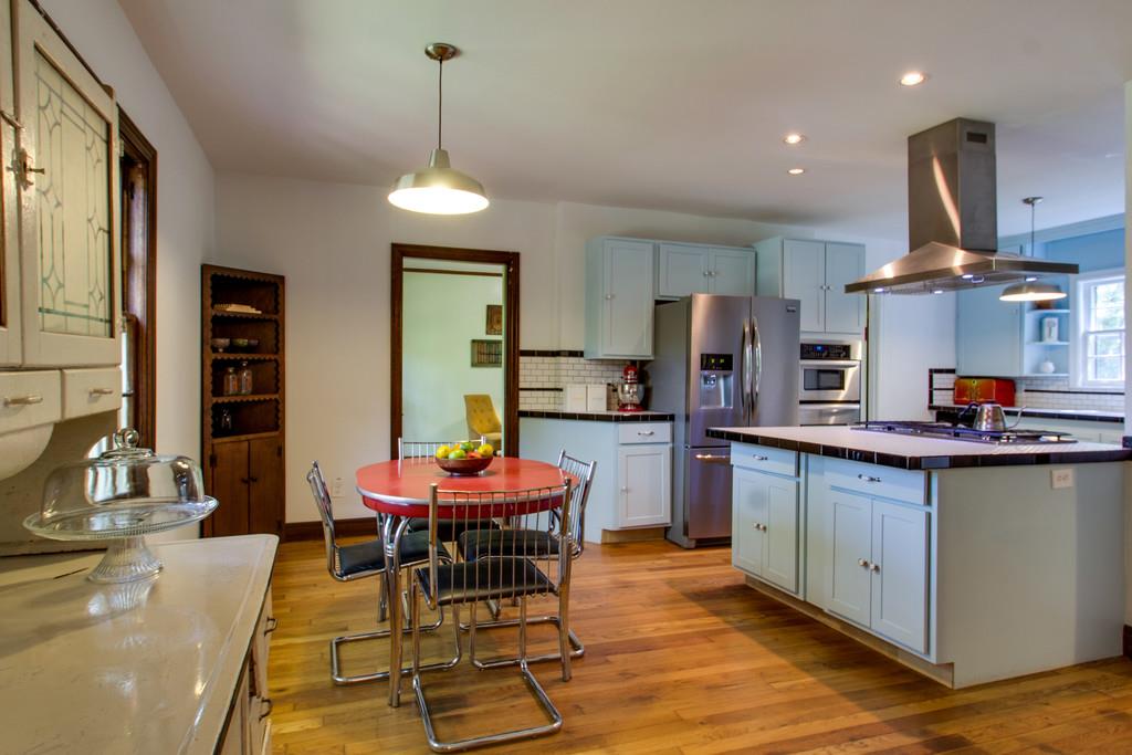 1109 Neelys Bend Road Madison, TN 37115 - Photo 10 of 30 a kitchen with stainless steel appliances a dining table chairs and wooden floor