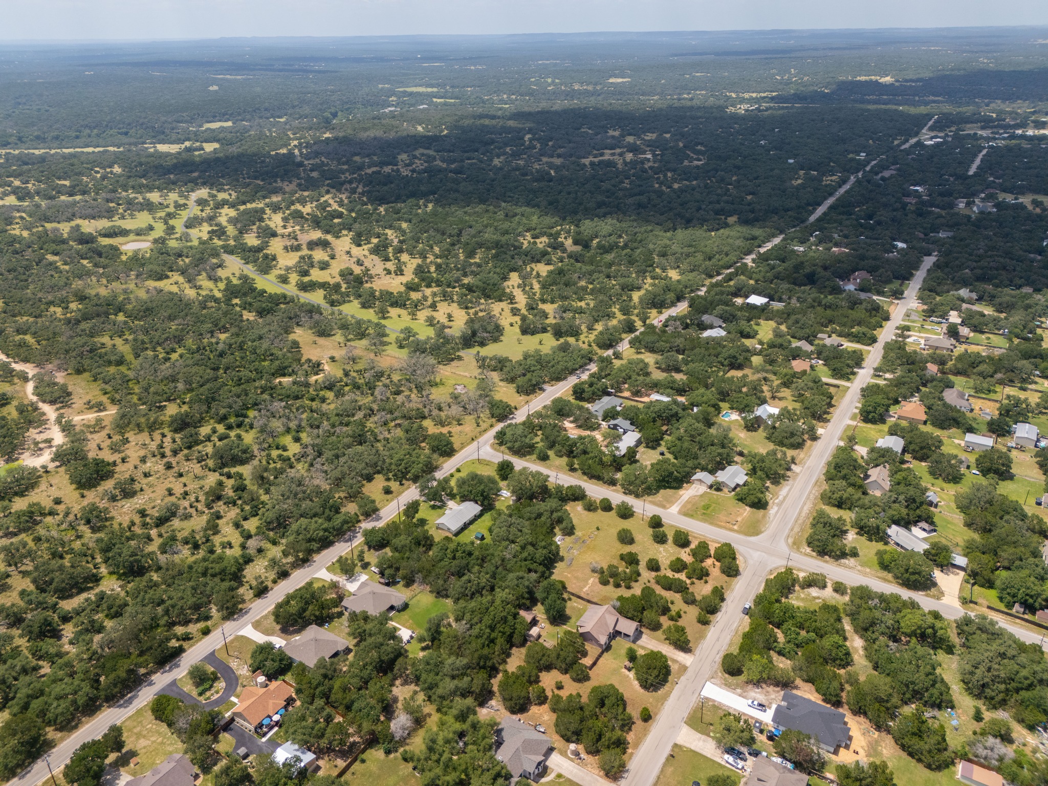 1170 Misty Lane Spring Branch, TX 78070 - Photo 8 of 24 An aerial perspective showcases the vast landscape and scattered residential areas.