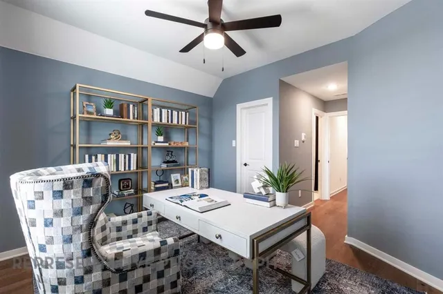 a living room with furniture and a bookshelf