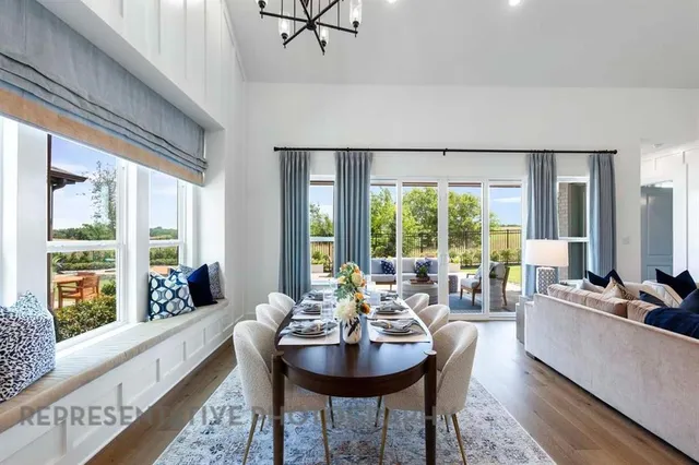 a living room with fireplace furniture and a large window