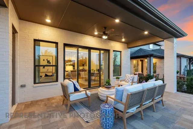 a living room with furniture and large windows