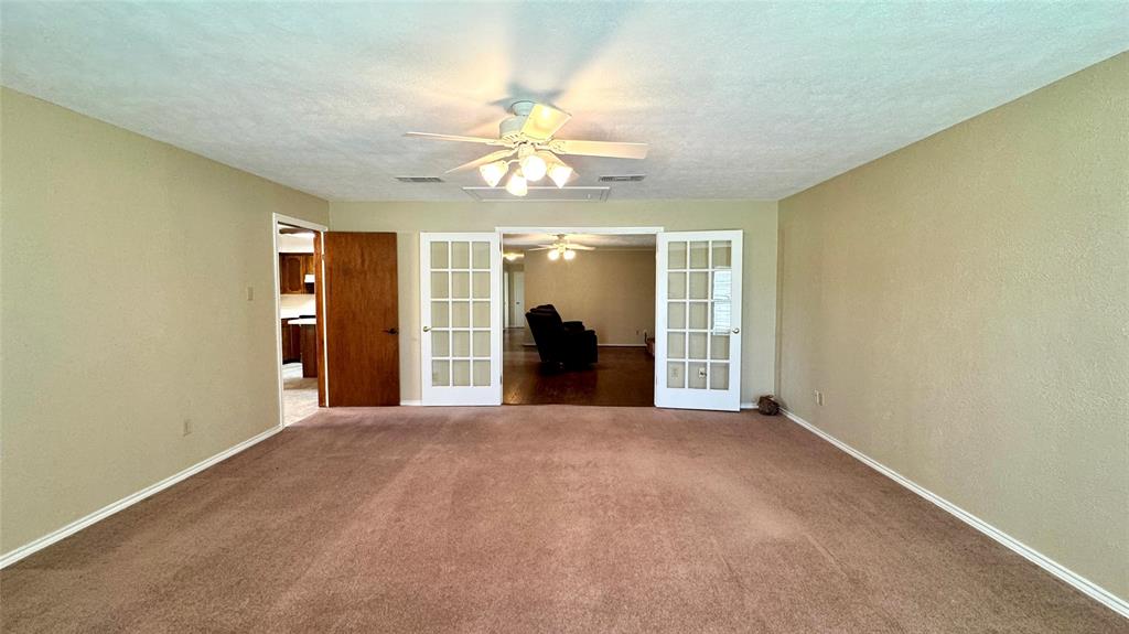 2050 Griffith Avenue Terrell, TX 75160 - Photo 11 of 27 a view of a big room with windows and chandelier fan