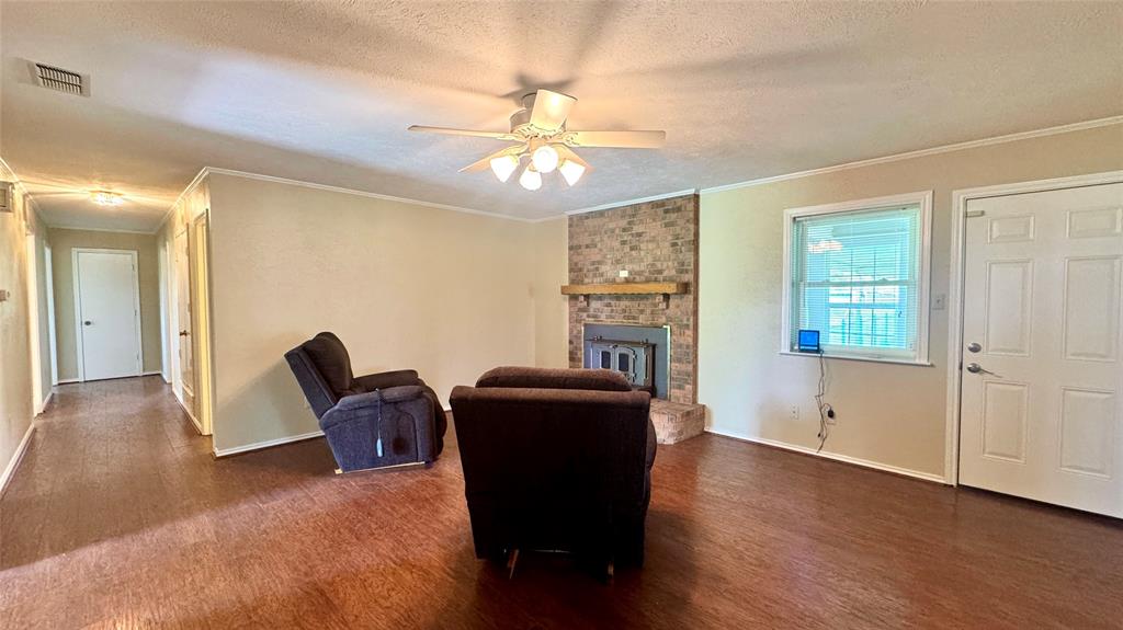 2050 Griffith Avenue Terrell, TX 75160 - Photo 12 of 27 a living room with furniture and a chandelier