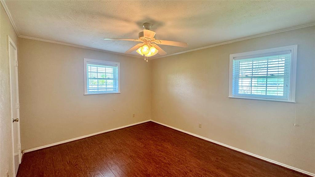 2050 Griffith Avenue Terrell, TX 75160 - Photo 16 of 27 a view of an empty room with wooden floor and a window