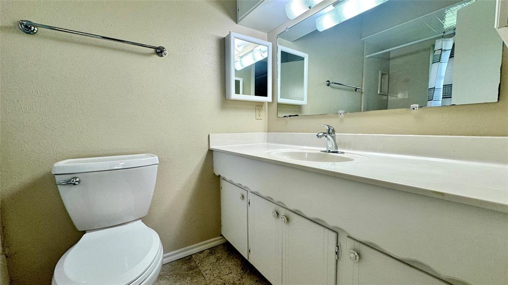 2050 Griffith Avenue Terrell, TX 75160 - Photo 17 of 27 a bathroom with a toilet sink and mirror
