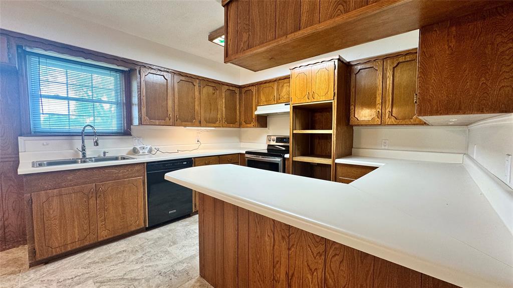 2050 Griffith Avenue Terrell, TX 75160 - Photo 5 of 27 a kitchen with stainless steel appliances a sink and a stove