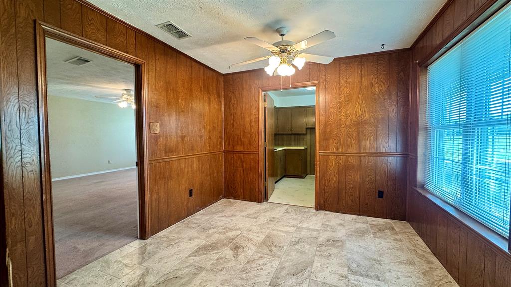 2050 Griffith Avenue Terrell, TX 75160 - Photo 7 of 27 a bedroom with a bed and a chandelier
