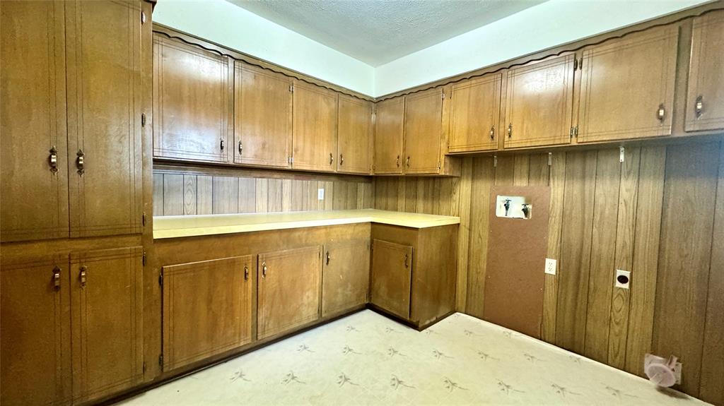 2050 Griffith Avenue Terrell, TX 75160 - Photo 9 of 27 a view of kitchen with granite countertop wooden cabinets
