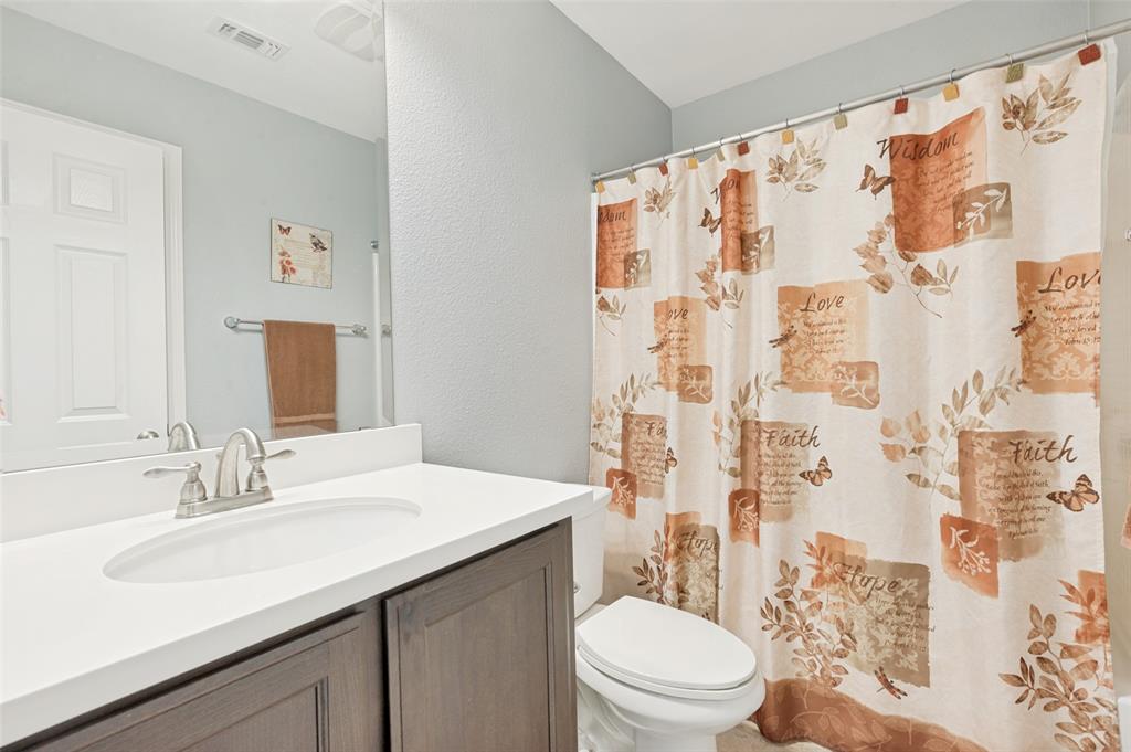 3905 Bridle Path Lane Sanger, TX 76266 - Photo 19 of 26 a bathroom with a sink and a mirror