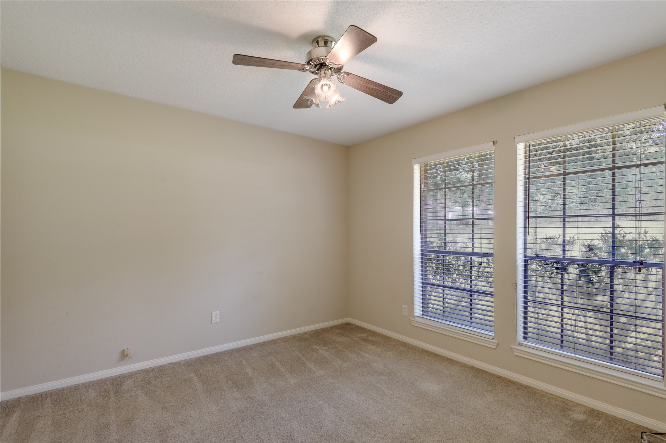 324 Red Oak Lane Trinity, TX 75862 - Photo 34 of 49 an empty room with windows and fan