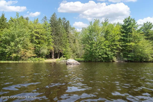 a living room with furniture a flat screen tv and windows