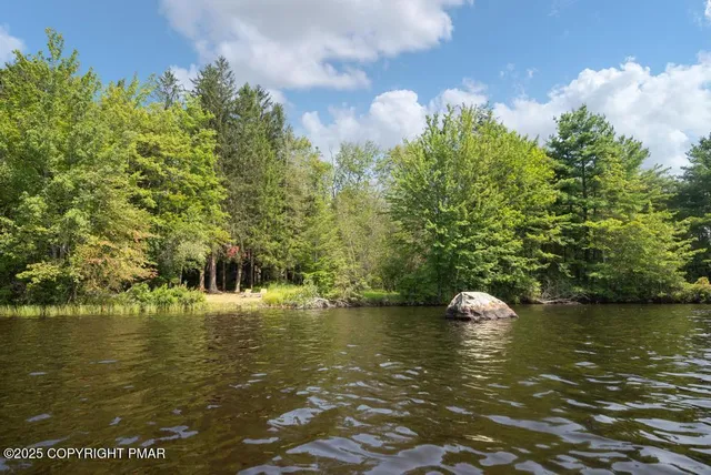 a bedroom with furniture and a mirror