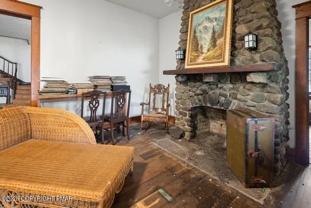 a living room with fireplace furniture and a floor to ceiling window