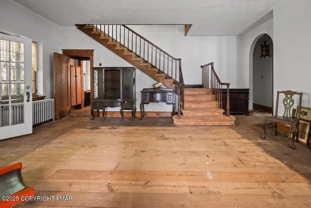 a view of entryway and hall with wooden floor