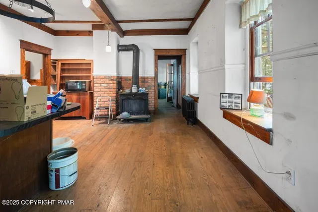 a view of a room with wooden floor and windows