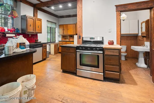 a view of a room with wooden floor and door