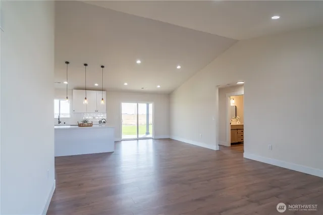 a view of a kitchen and an empty room