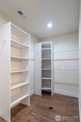 a view of walk in closet with empty racks