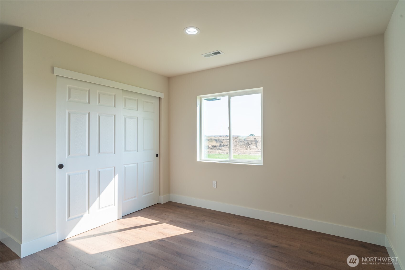 70 Sunwest Drive Ephrata, WA 98823 - Photo 25 of 34 an empty room with wooden floor and windows