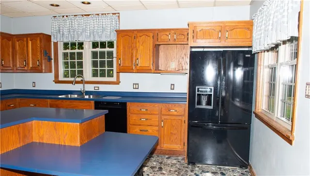 a kitchen with stainless steel appliances granite countertop a refrigerator and a stove