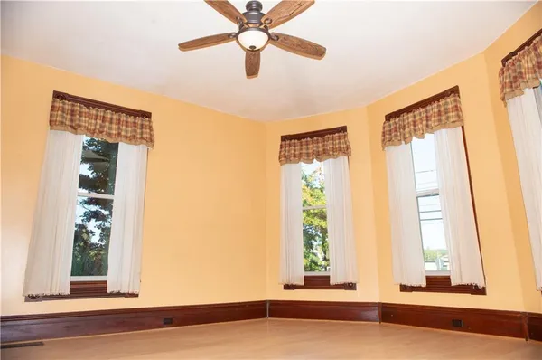 a view of a livingroom with a window and a ceiling fan