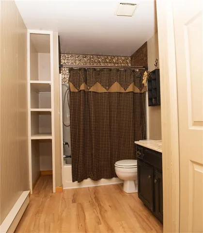 a bathroom with a sink a toilet a shower and a mirror