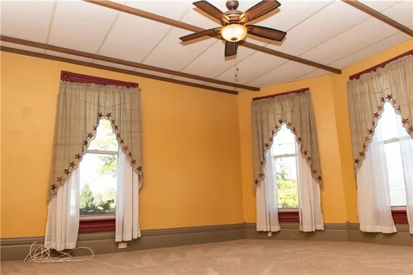 a view of a hallway with wooden floor and door