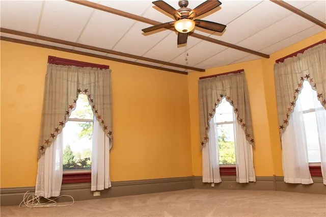 a view of a hallway with wooden floor and door