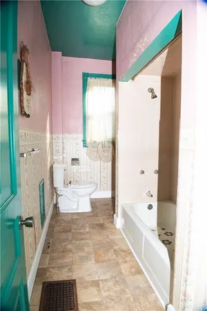 a large bathroom with a tub and shower