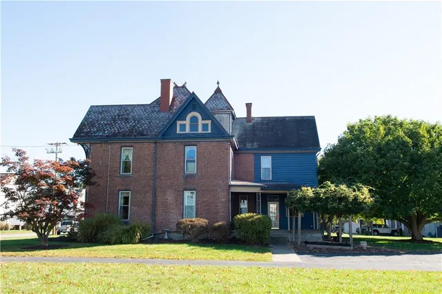 a front view of a house with garden